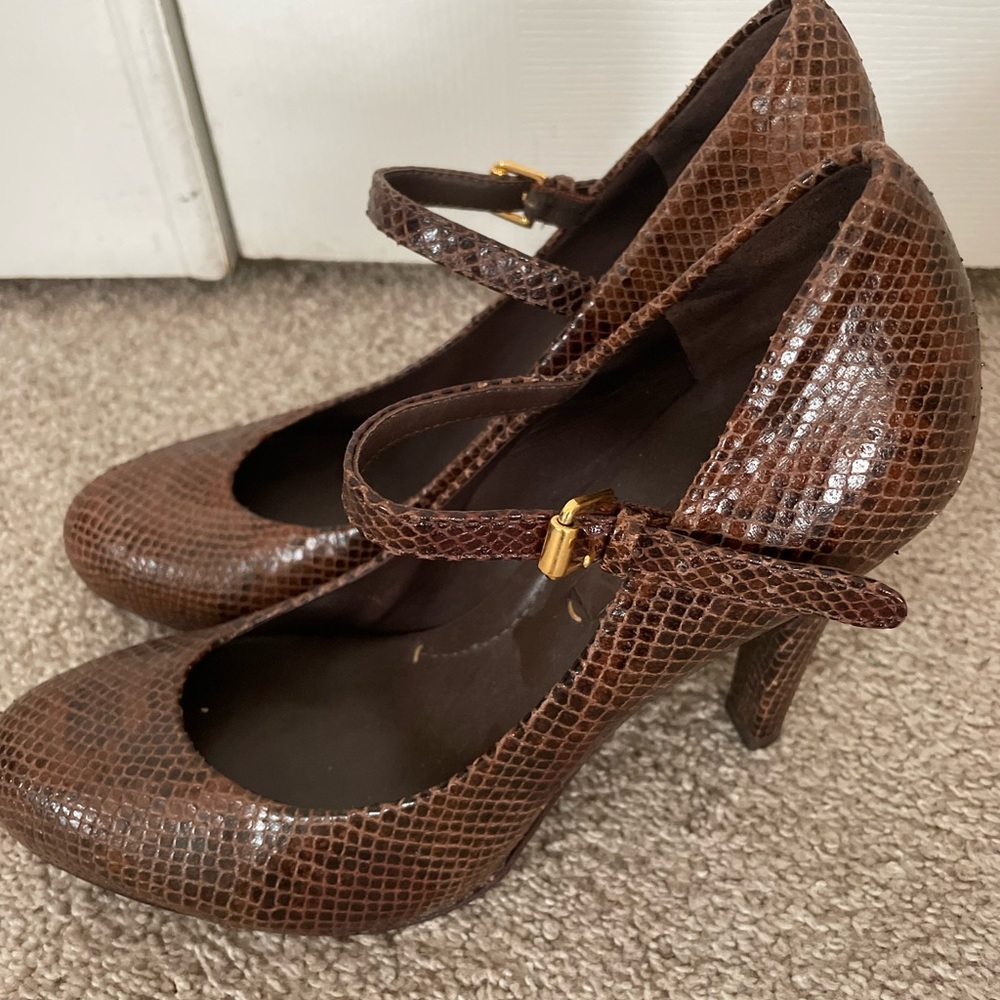 BCBGMaxAzria brown and gold snakeskin pumps.